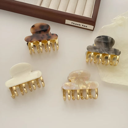 Acetate hair barrettes with metal alloy grip in leopard print, white, and ink colour options