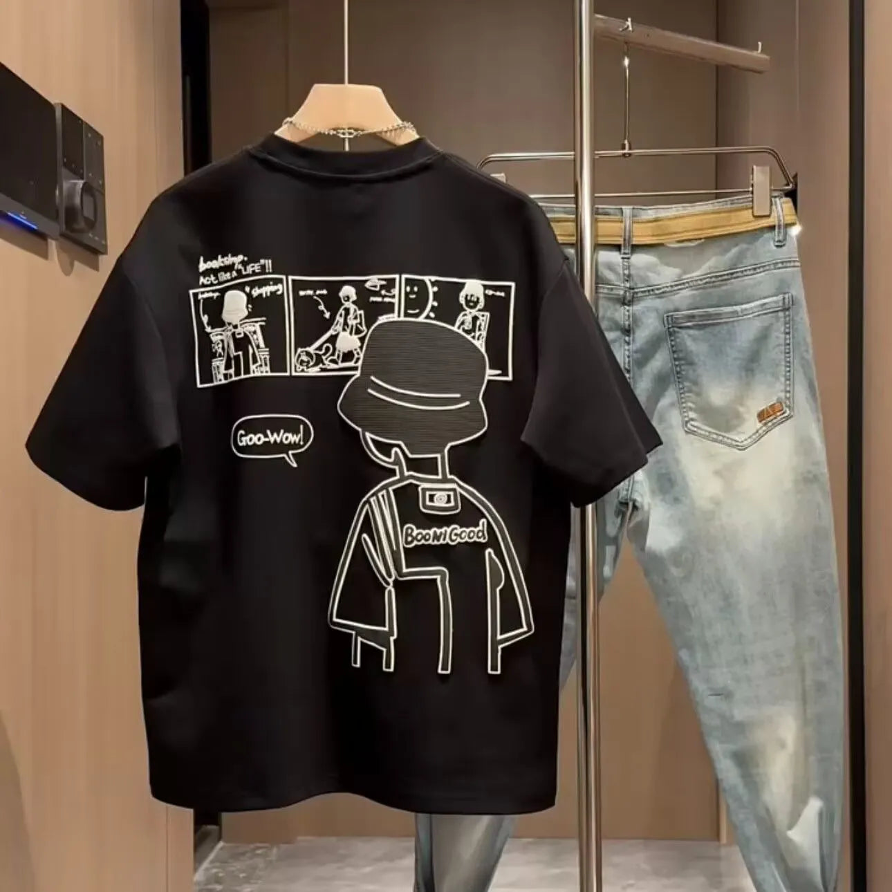 Men's black cotton short sleeve T-shirt featuring a cartoon print design on the front.