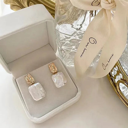 Geometric quadrilateral freshwater pearl stud earrings in purple, white or pink colours with alloy settings