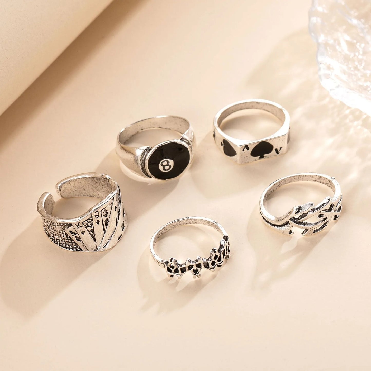 Black adjustable ring with a raised polished spade card suit motif on a wide band.