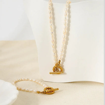 Freshwater pearl and stainless steel geometric pendant necklace with matching bracelet set.