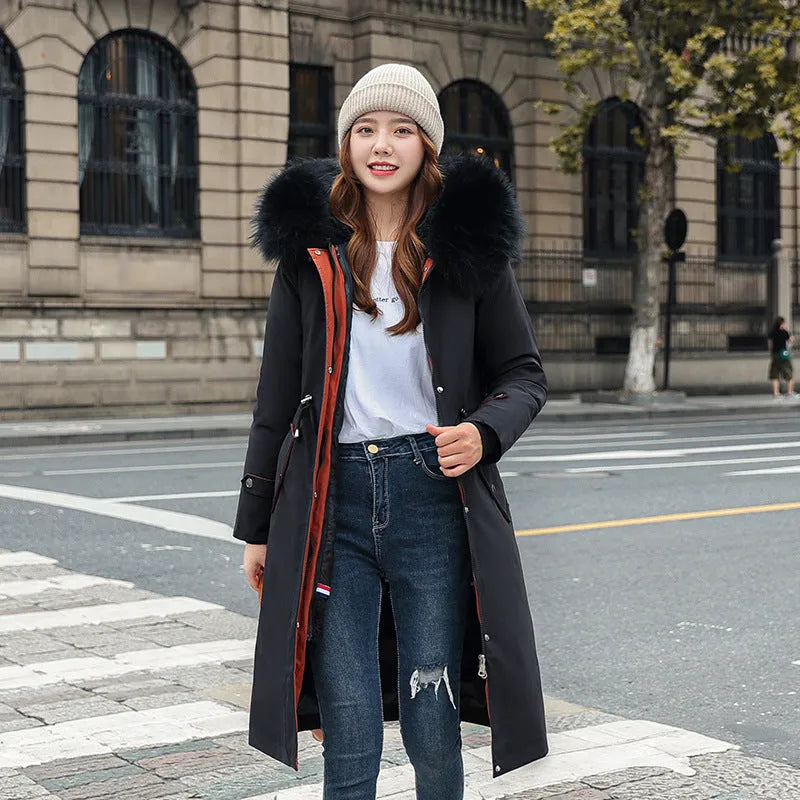 Women's long padded beige trench coat with a fleece lining, shown on a model.