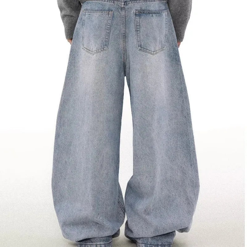 Man wearing retro blue washed straight leg distressed jeans with a mid-rise waist.