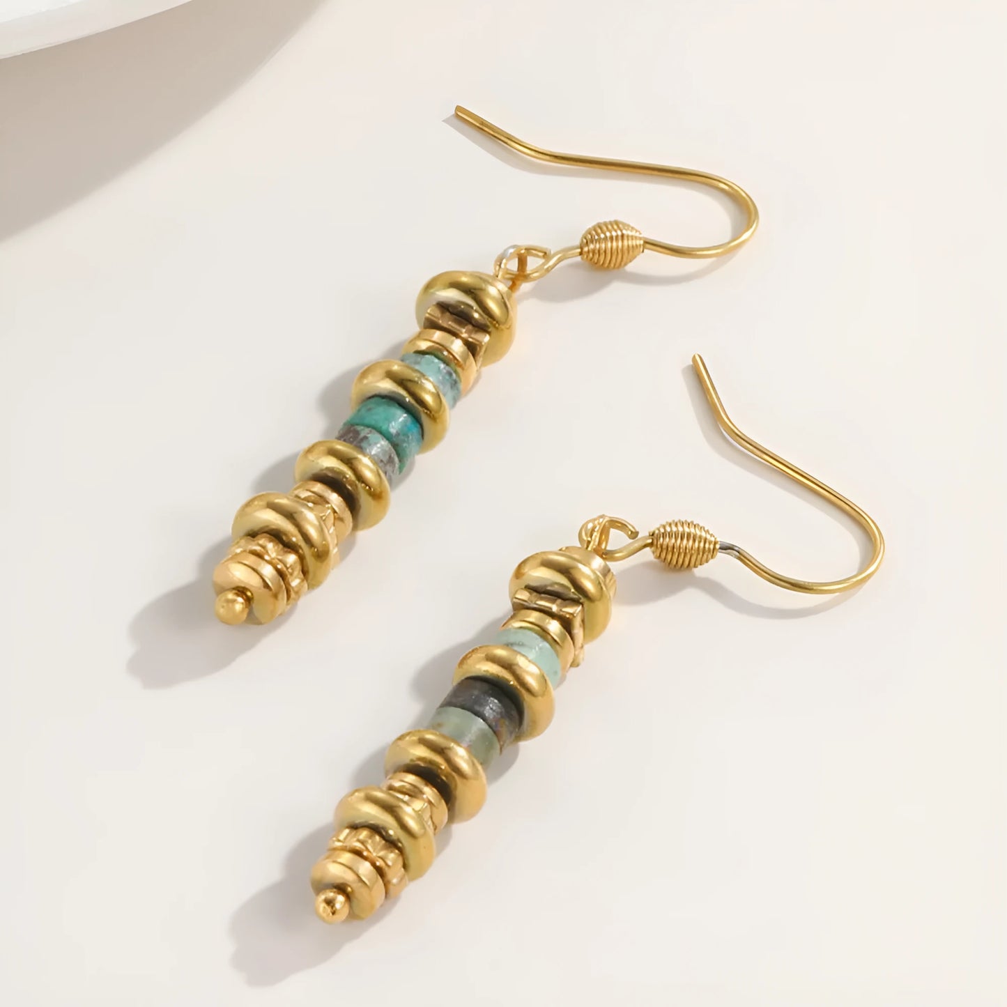 Geometric titanium steel dangle earrings with 18K gold plating on a white background.