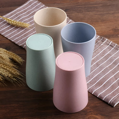A cylindrical wheat straw plastic bathroom cup in a Nordic colour, holding toothbrushes.