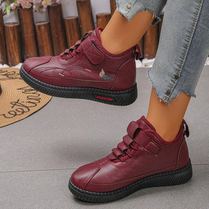 Women's black velvet indoor shoes with a non-slip rubber sole and low tube sock design.