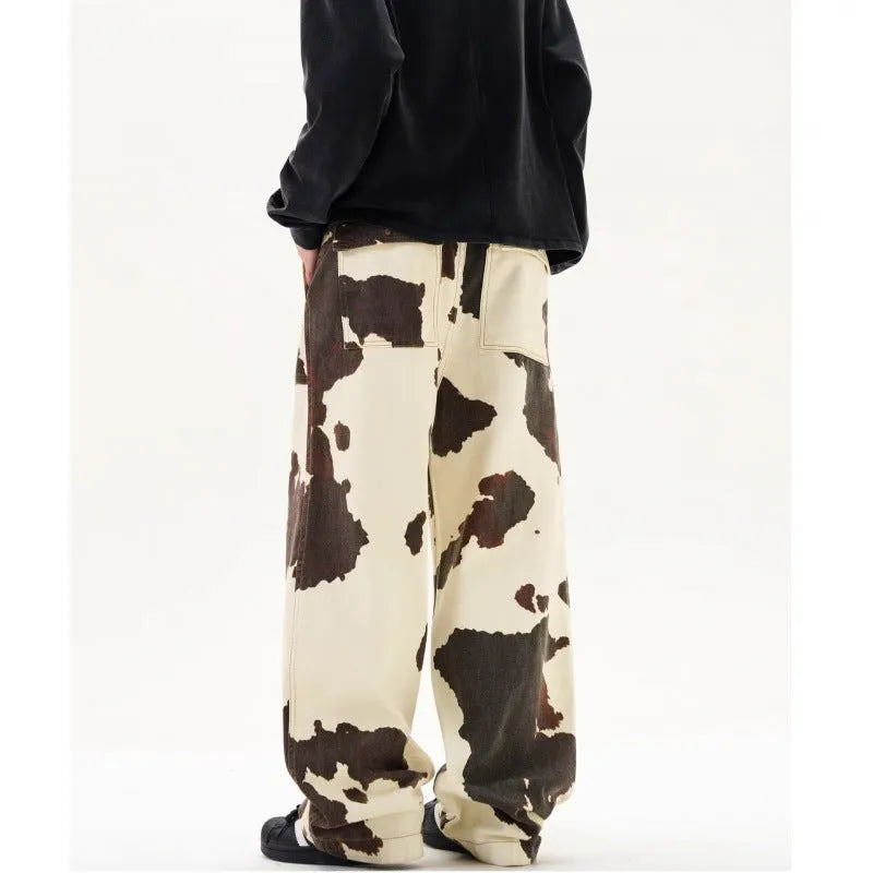 Men's straight-leg casual trousers with a retro-style cows pattern print in a brown colour.