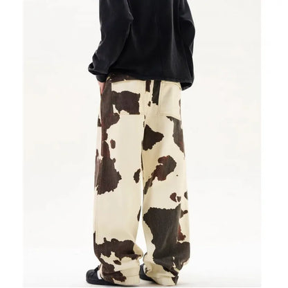 Men's straight-leg casual trousers with a retro-style cows pattern print in a brown colour.