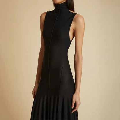 Grey slim-fit cotton dress with a half turtleneck and backless design on a mannequin.
