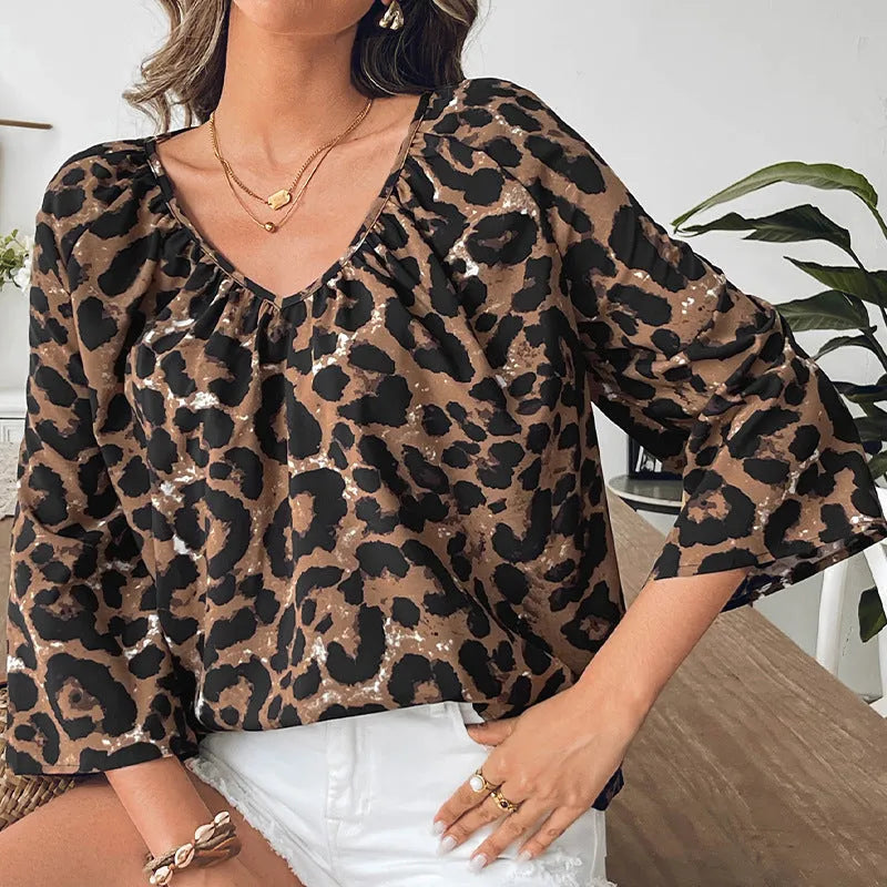Women's leopard print pullover top in polyester with V-neck and half sleeves for commuting, available in sizes S, M, L, XL with pleating detail and multicolour pattern.