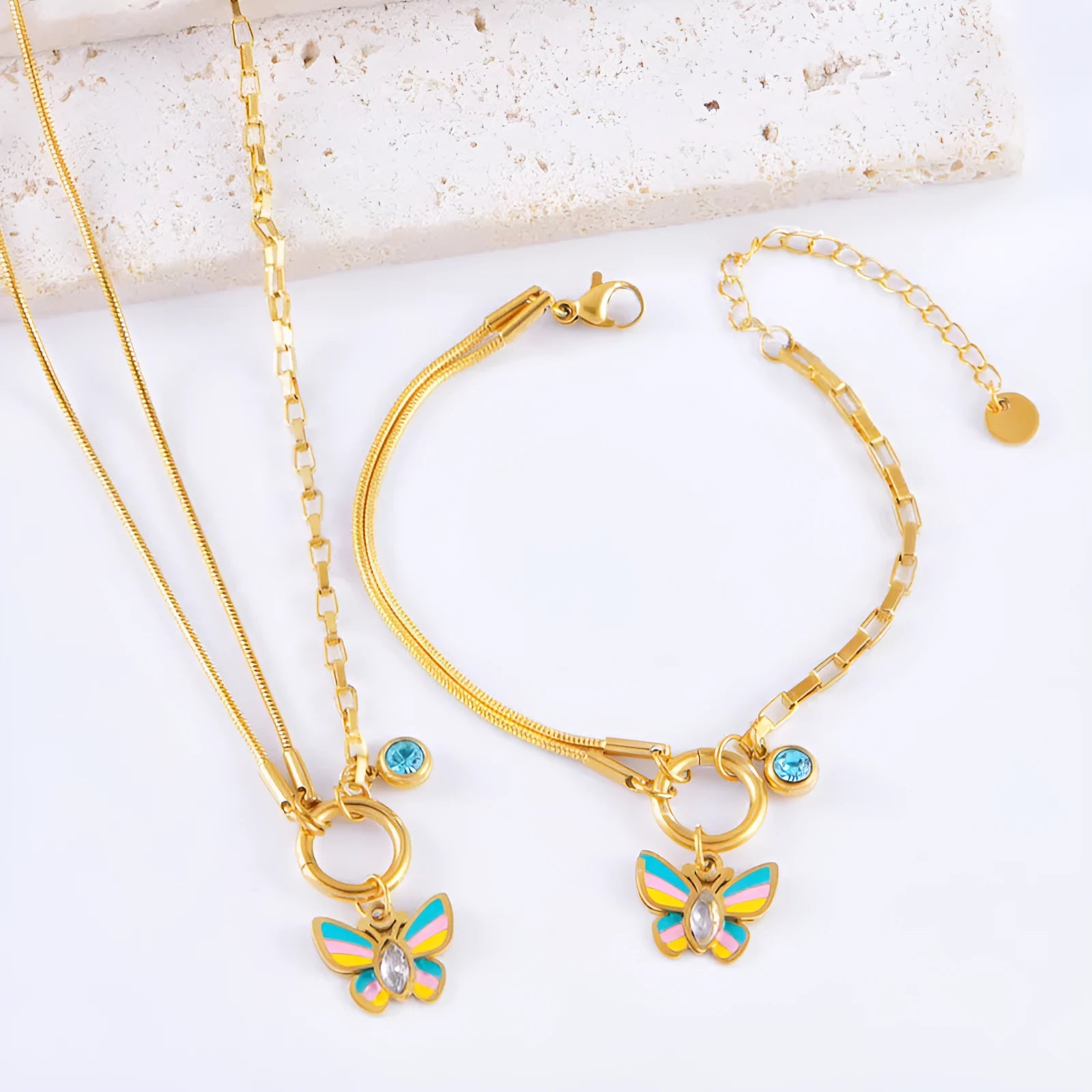 Gold-coloured titanium steel butterfly necklace and matching bracelet set on a snake bone chain.