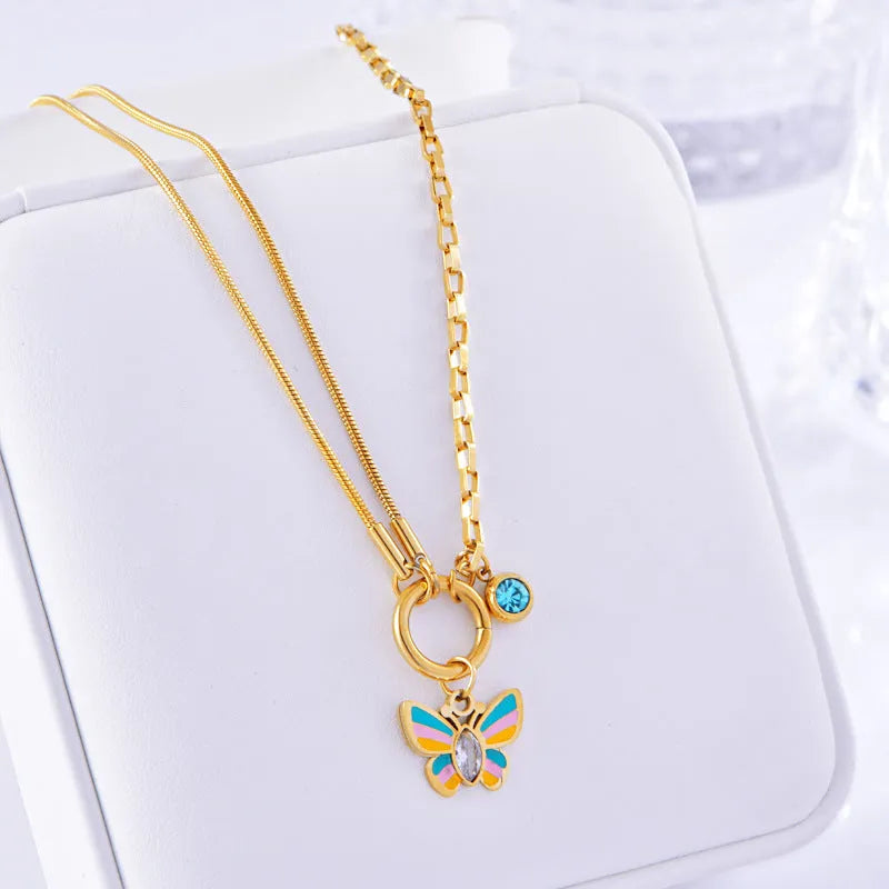 Gold-coloured titanium steel butterfly necklace and matching bracelet set on a snake bone chain.