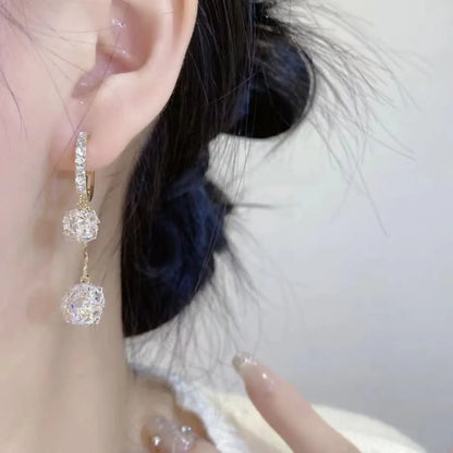 Silver drop earrings with tassel and rhinestone details on copper ear clips