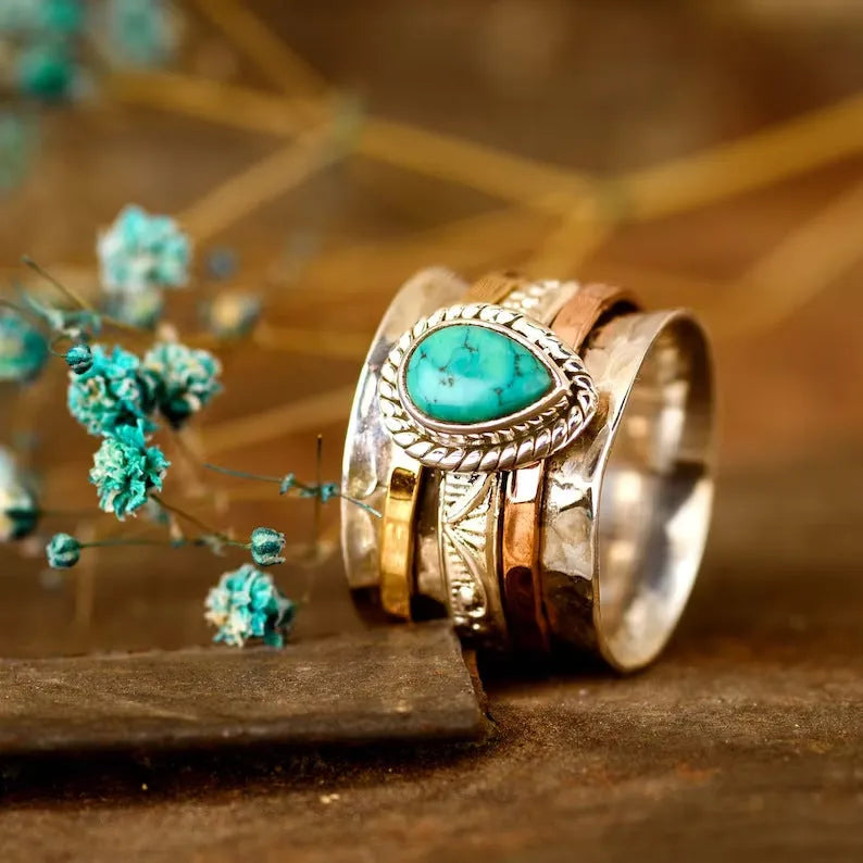 Retro green pine three-colour alloy ring for men and women on a plain background.