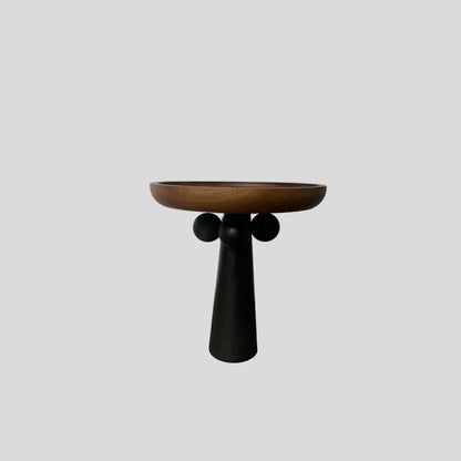 Round beech wood tray with high legs for candles and aromatherapy accessories on wooden table