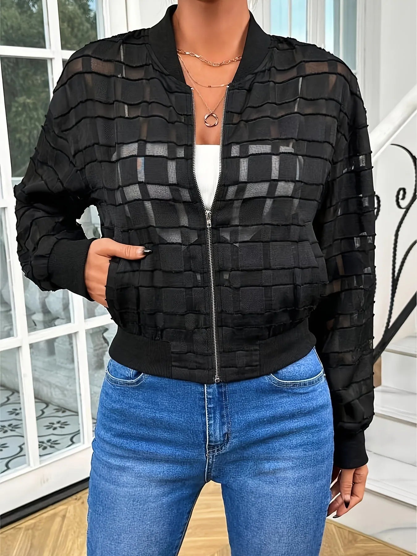 Black women's casual jacket with geometric pattern, long sleeves, and a full front zip.