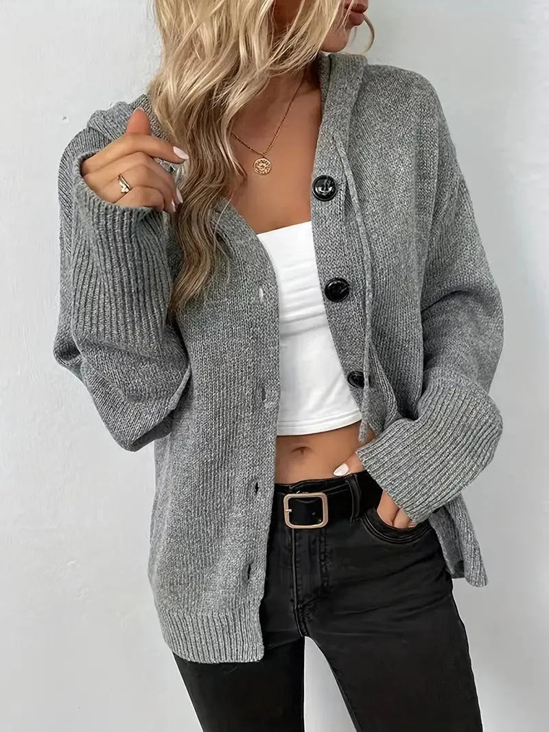 Loose fit grey hooded cardigan sweater with long sleeves on a hanger.