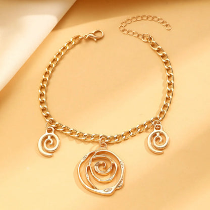 Gold spiral donut alloy jewellery set showing adjustable necklace, matching bracelet, and ear hooks on a plain background.