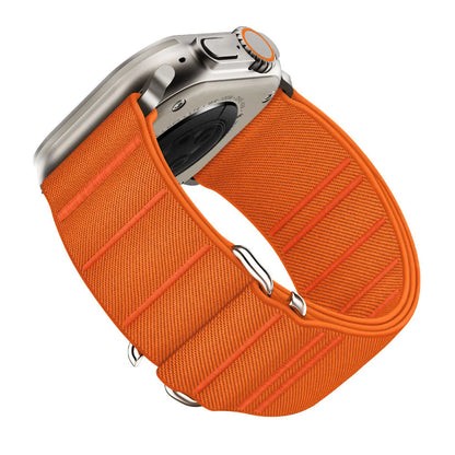 Elastic nylon Apple Watch band with stainless steel buckle shown in Army Green colour on a wrist.
