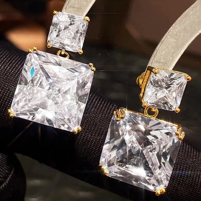 A pair of geometric square copper earrings for women in a gold colour finish.