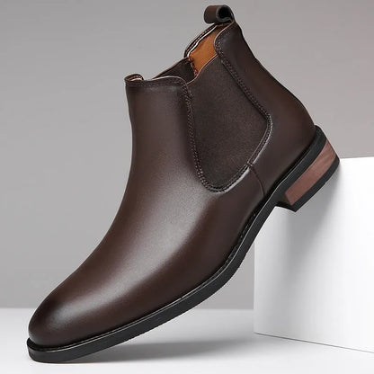 Men's black Chelsea boots with pointed toe design and sewing thread detailing on artificial PU upper