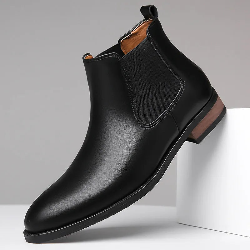 Men's black Chelsea boots with pointed toe design and sewing thread detailing on artificial PU upper