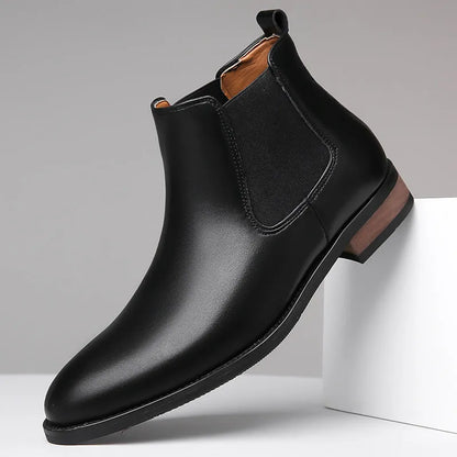 Men's black Chelsea boots with pointed toe design and sewing thread detailing on artificial PU upper