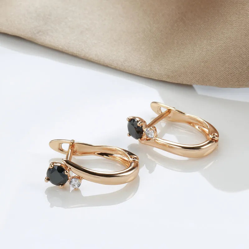 Gold-coloured women's drop earrings with black agate inlay in geometric design