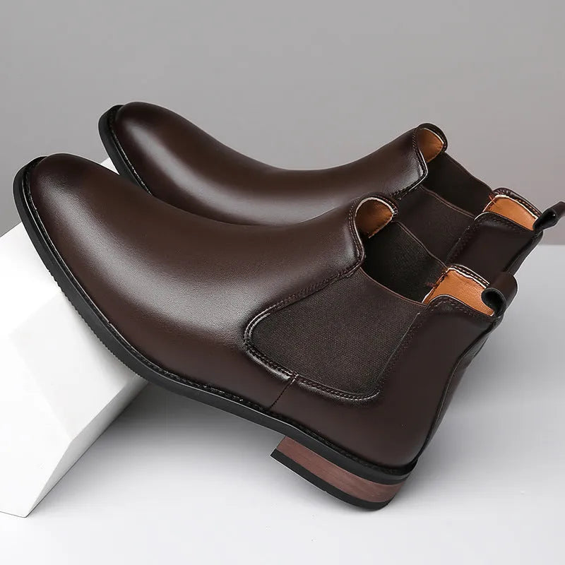 Men's black Chelsea boots with pointed toe design and sewing thread detailing on artificial PU upper