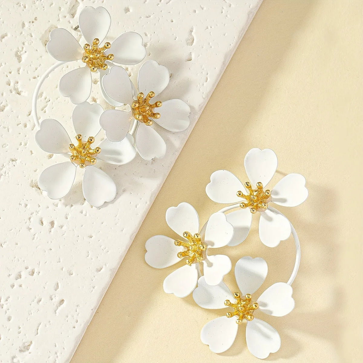A pair of retro-style flower-shaped earrings for women, shown in black and white colour options.