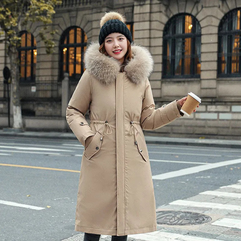 Women's long padded beige trench coat with a fleece lining, shown on a model.