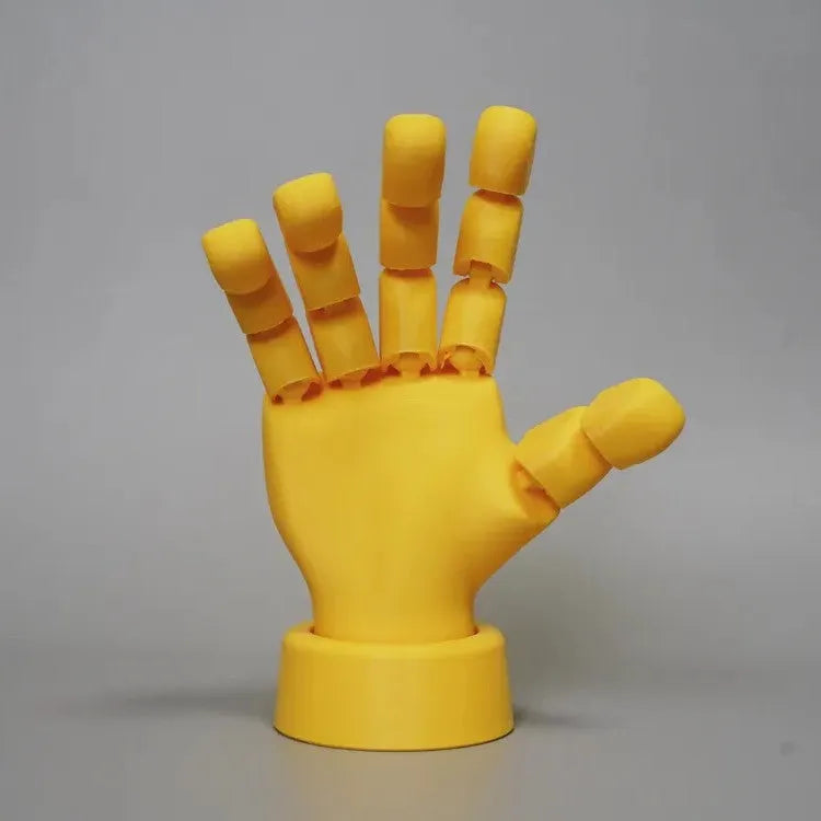 Yellow movable joint hand ornament showing articulated design and 5*5.38*7.5cm dimensions