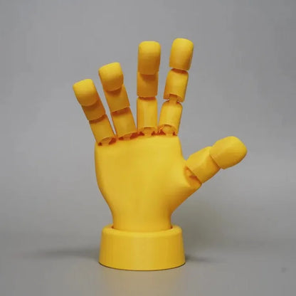 Yellow movable joint hand ornament showing articulated design and 5*5.38*7.5cm dimensions