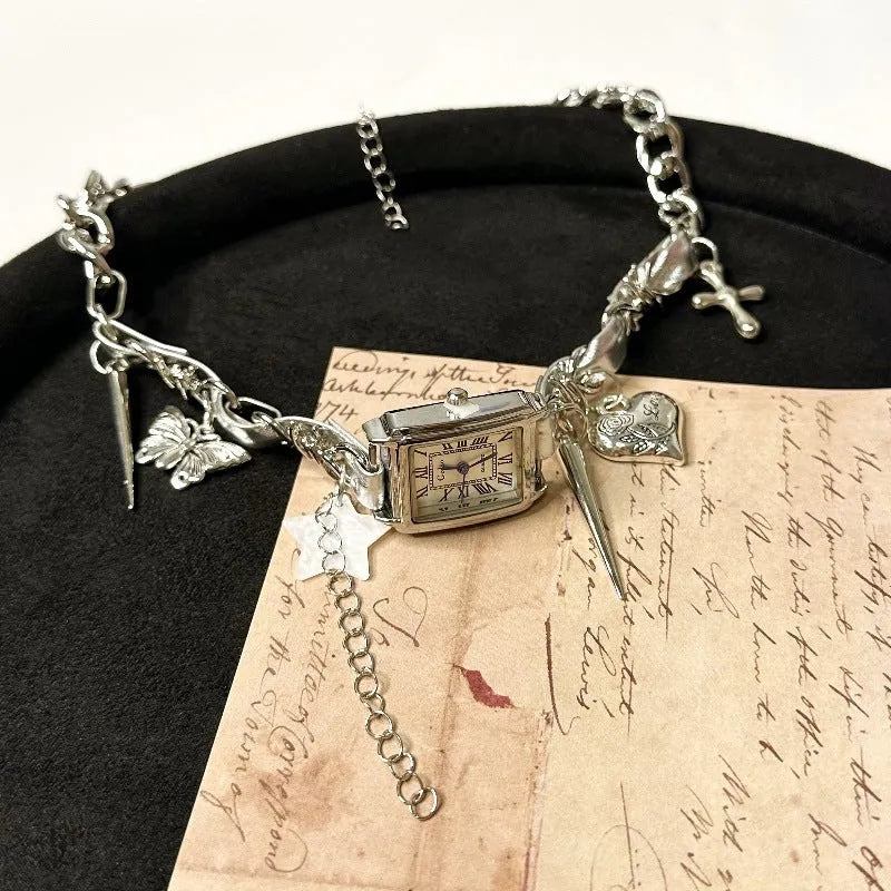 Dark women's layered necklace with twin chains, a cross pendant, and textured hemp-style links.