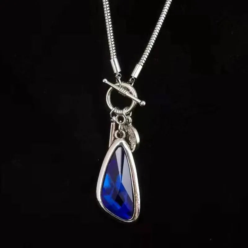 Women's geometric alloy pendant on a long snake bone chain necklace in blue, champagne, or grey.