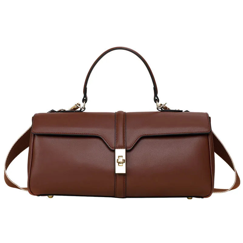 Women's cylindrical cowhide messenger bag in black with multiple internal compartments and shoulder strap