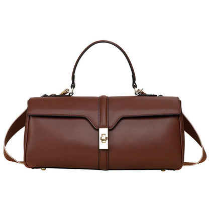 Women's cylindrical cowhide messenger bag in black with multiple internal compartments and shoulder strap