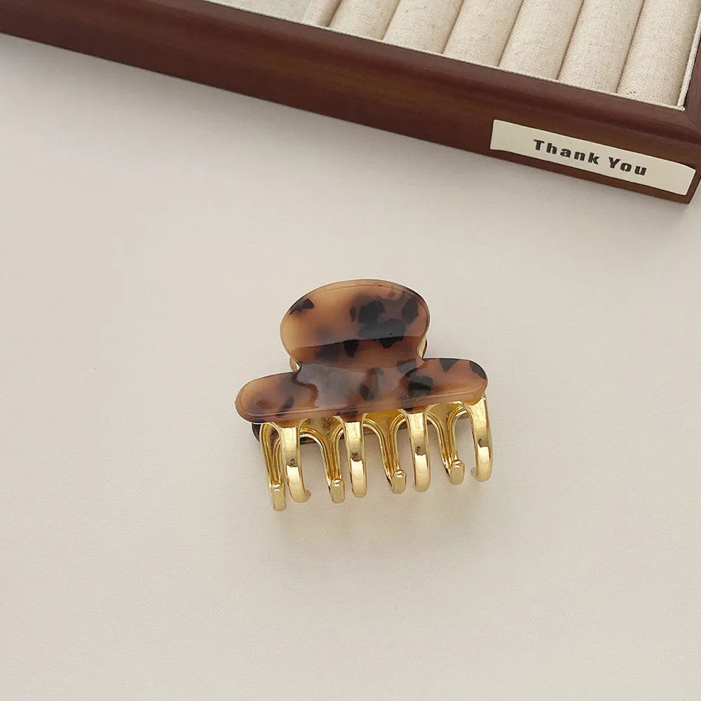 Acetate hair barrettes with metal alloy grip in leopard print, white, and ink colour options