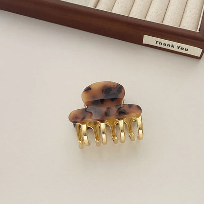 Acetate hair barrettes with metal alloy grip in leopard print, white, and ink colour options