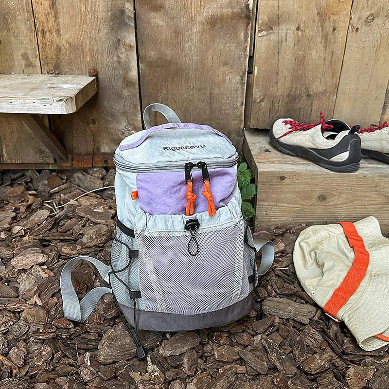 Waterproof nylon casual backpack in blue with curved shoulder straps and fold details