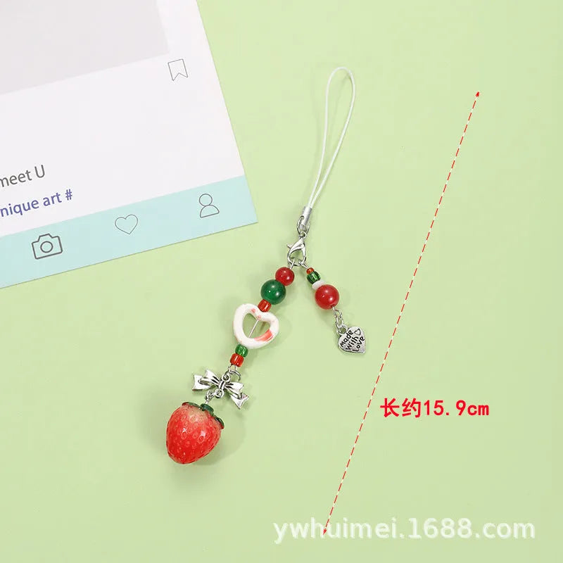Plastic and resin fruit charm keychain with apple, strawberry designs on silver rope