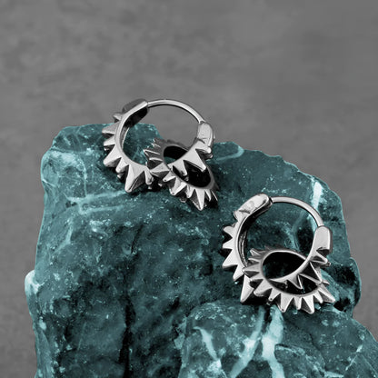 Polished steel round hoop earrings with a 2.5cm diameter on a plain background.