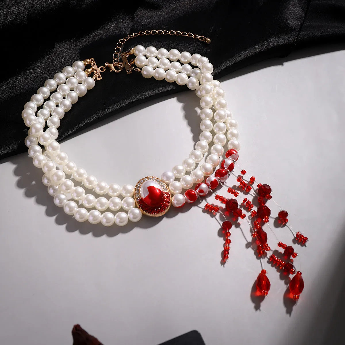 Halloween jewellery set with pearl collar design in gothic retro style showing necklace, bracelet and earrings