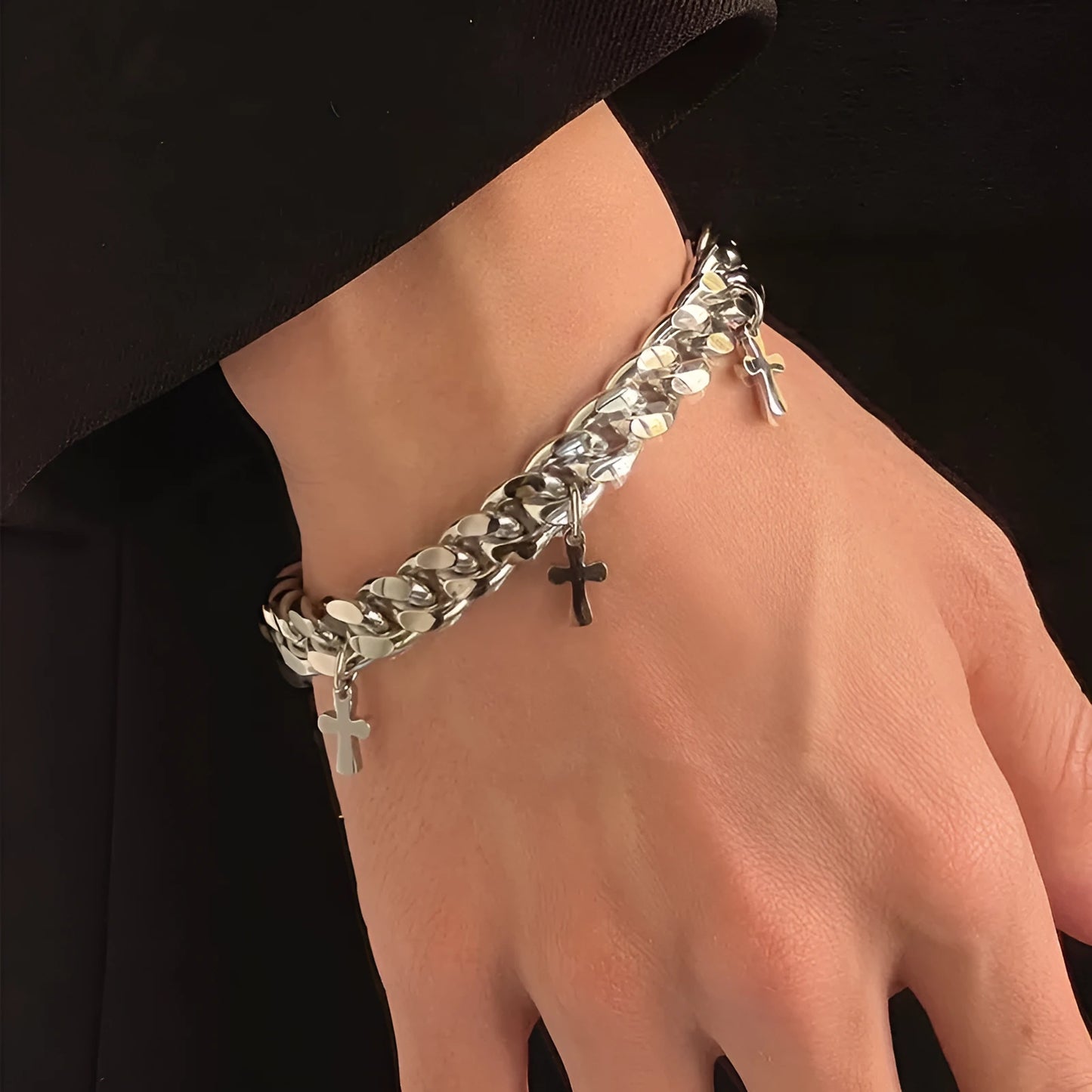 Men's titanium steel bracelet with a geometric cross design on a wrist.