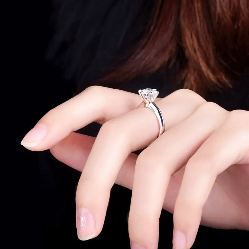 White gold plated zircon ring with six-claw setting and geometric shape on white copper base