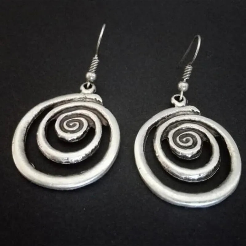 Retro geometric spiral earrings with a distressed silver finish.