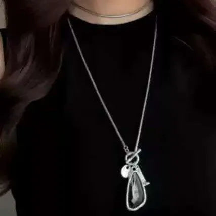 Women's geometric alloy pendant on a long snake bone chain necklace in blue, champagne, or grey.