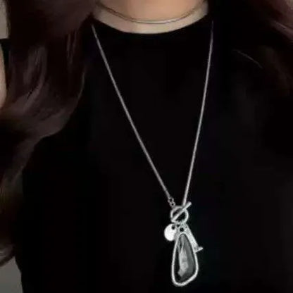 Women's geometric alloy pendant on a long snake bone chain necklace in blue, champagne, or grey.