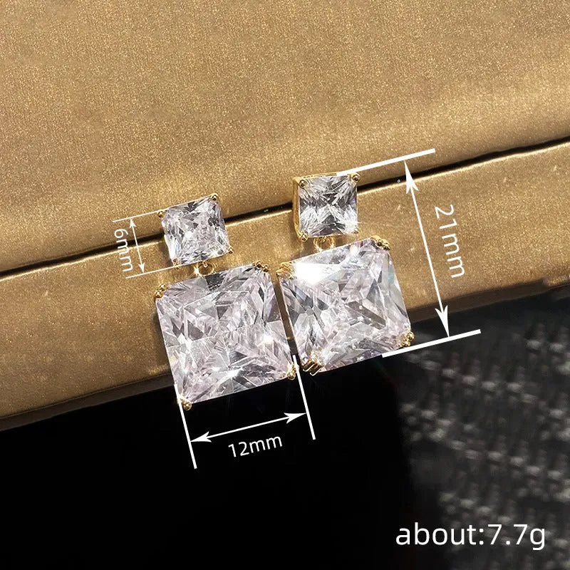 A pair of geometric square copper earrings for women in a gold colour finish.