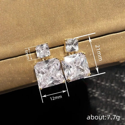 A pair of geometric square copper earrings for women in a gold colour finish.